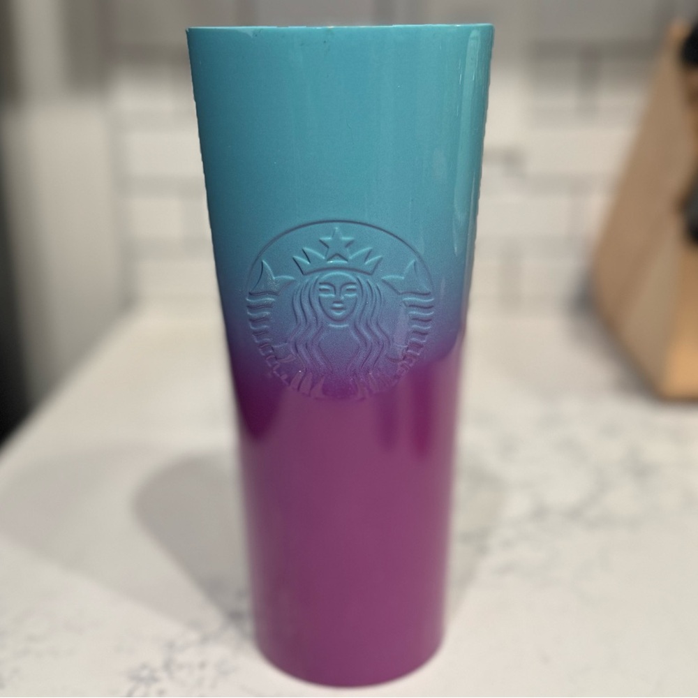 Insulated Starbucks cup with lid.